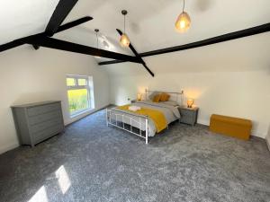 a bedroom with a bed and a dresser and a window at Yr Hen Bopty (The Old Bakery) in Pontypridd