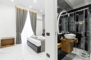 a bathroom with a bed and a sink at Sant'Angelo Suites in Naples +113 photos