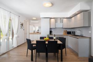 a kitchen and dining room with a table and chairs at Villa Irena in Medulin