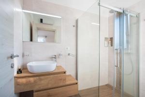 a bathroom with a sink and a glass shower at Villa Irena in Medulin +25 photos