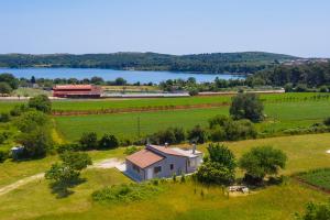 an aerial view of a house in a field with a lake at Villa Irena in Medulin