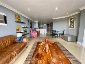a living room with a couch and a table at Apartment The Sails in Durban