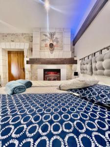 a bedroom with two beds and a fireplace at VILLA DEL CASTAGNOL in Saint-Nexans +69 photos
