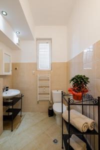 a bathroom with a toilet and a sink at Spacious 3 Bedroom Home in Sofia's Top Center in Sofia