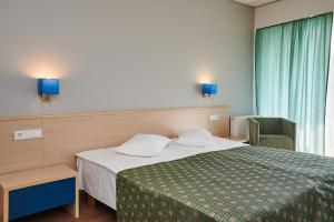 Un pat sau paturi într-o cameră la Asa Spa Hotel