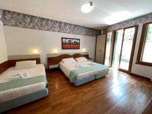 a hotel room with two beds in a room at Hotel Meridiana in Sirmione +37 photos