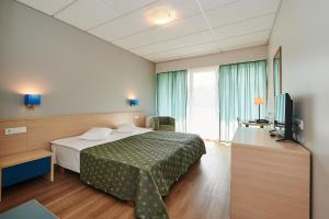 a hotel room with a bed and a television at Asa Spa Hotel in Kuressaare