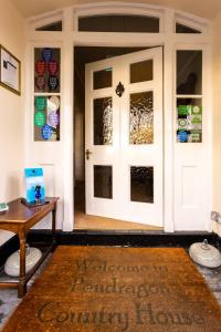 una entrada a una casa comunitaria con puerta en Pendragon Country House, en Camelford