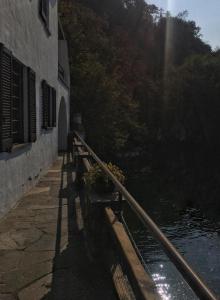 a row of benches next to a building next to a river at Gioconda Villa in Varenna