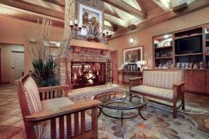sala de estar con chimenea, sillas y mesa en Econo Lodge Pigeon Forge Riverside, en Pigeon Forge