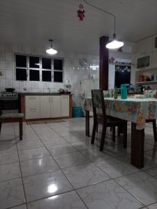 a kitchen with a table and chairs in a room at Caiowa Floripa guesthouse in Florianópolis