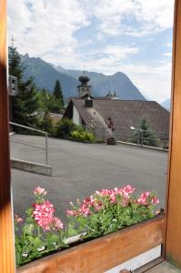 a view from a window of a street with flowers at Appartement Rietli in Triesenberg