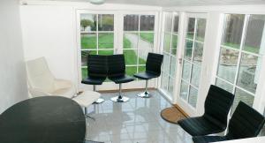 a room with four chairs and a room with windows at Sædding Strandvej (ID 119) in Esbjerg