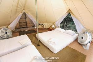 a tent with two beds and a fan at Pitahaya Glamping in Cabo Rojo