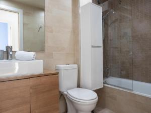 a bathroom with a toilet and a sink and a shower at Matarolux23 in Mataró