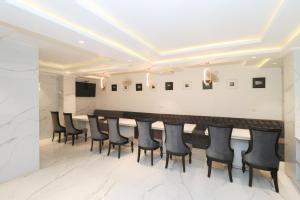 a conference room with a long table and black chairs at Hotel View - A Boutique Hotel in New Delhi