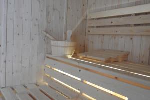 a sauna with a bucket on a shelf at House of Juniper in Broadford