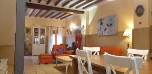 a living room with a table and chairs at La Xaquera in Busot