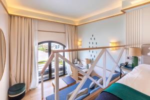 a hotel room with a bed and a balcony at Hôtel Le Café de Paris in Biarritz