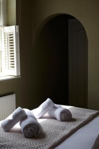 a towel laying on a bed in a bedroom at The Lion Inn in Winchcombe