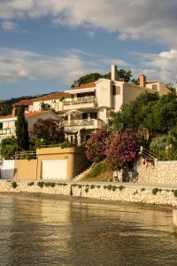 a building on the side of a river at Villa Jadrana in Rab