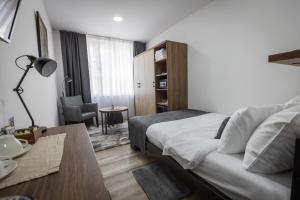 Postel nebo postele na pokoji v ubytování Vila Greta by Hotel Ramonda