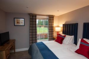 A bed or beds in a room at Parkside, The Loch Ness Cottage Collection