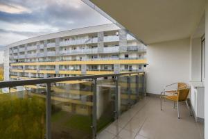 an apartment balcony with a view of a building at Marcelin Estate Apartments by Renters in Poznań