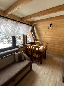 a living room with a couch and a table at U Maćka in Białka Tatrzańska