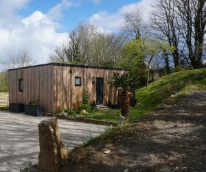 a small wooden house with a driveway at Bijou For Two in Penzance