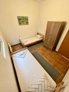 a small room with two beds and a cabinet at Apartman Start in Pale