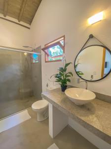 a bathroom with a sink and a toilet and a mirror at CASA RENASCER in Trancoso