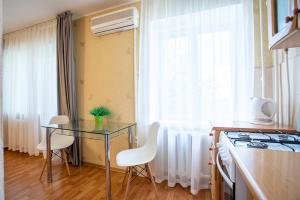 a kitchen with a glass table and a stove at Apartment near Central Avenue in Mykolaiv