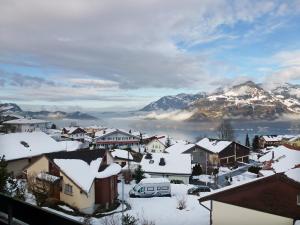 a town covered in snow with mountains in the background at Apartment Mansalo by Interhome in Emmetten