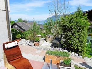 a patio with a chair and some plants at Apartment Mansalo by Interhome in Emmetten