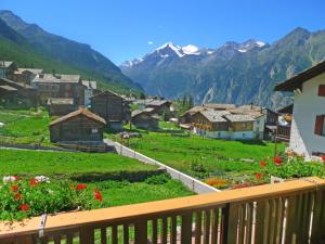 a view from a balcony of a village with mountains at Apartment Wiedersehn Dachgeschoss by Interhome in Grächen