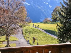 two people riding bikes on a path in a park at Apartment Bodmisunne by Interhome in Grindelwald