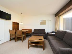 a living room with a couch and a table at Apartment Ringstrasse Apt 412 by Interhome in Leukerbad