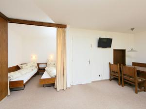 a living room with a couch and a table at Apartment Ringstrasse Apt 412 by Interhome in Leukerbad