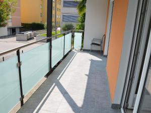 a balcony of a building with a swimming pool at Apartment Residenza Corallo-22 by Interhome in Ascona