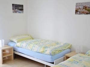 Bett in einem Zimmer mit 2 Einzelbetten in der Unterkunft Apartment Corallo - Utoring-22 by Interhome in Ascona