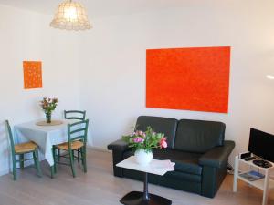 a living room with a couch and a table at Apartment Residenza Corallo-7 by Interhome in Ascona