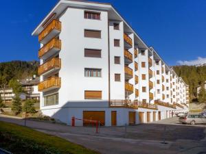 a white building with balconies on the side of it at Apartment Barzettes-Vacances B-10 by Interhome in Vermala