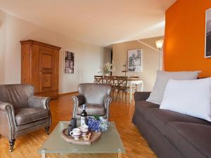 ein Wohnzimmer mit einem Sofa, 2 Stühlen und einem Tisch in der Unterkunft Apartment Suite Modern-18 by Interhome in Ascona