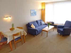 アローザにあるApartment Promenade - Utoring-34 by Interhomeのリビングルーム(青いソファ、テーブル付)