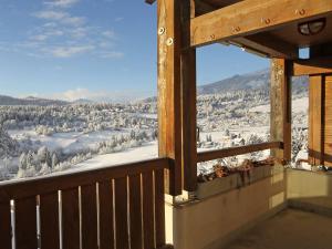 einen Blick vom Balkon eines Hauses mit schneebedeckten Bäumen in der Unterkunft Apartment Cristal Sura - 116 by Interhome in Flims