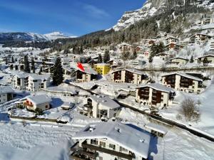 a village covered in snow with a mountain at Apartment Tavaun A11 by Interhome in Flims