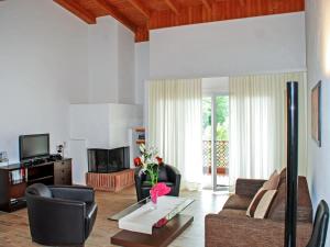 a living room with a couch and a table at Apartment Residenza Parcolago Apt 203 by Interhome in Caslano +32 photos
