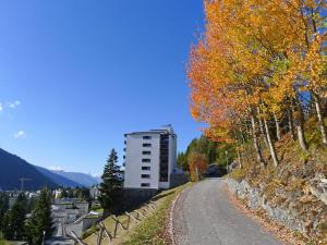 a road with a building on the side of a hill at Apartment Guardaval - Utoring-1 by Interhome in Davos