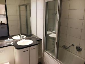 a bathroom with two sinks and a shower at Apartment Apt C 031 by Interhome in Disentis